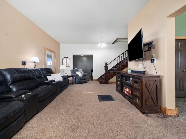 carpeted living room with a notable chandelier