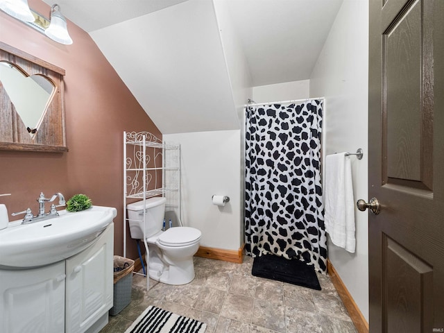 bathroom with vanity, curtained shower, toilet, and vaulted ceiling