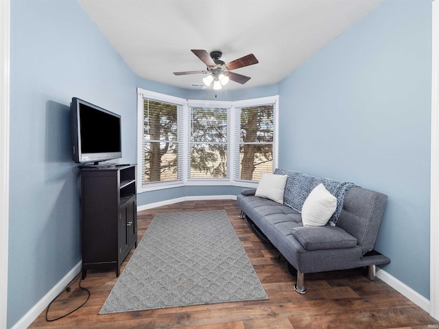 sitting room featuring dark hardwood / wood-style floors and ceiling fan