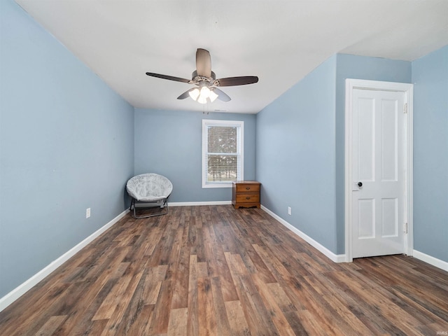 spare room with ceiling fan and dark wood-type flooring