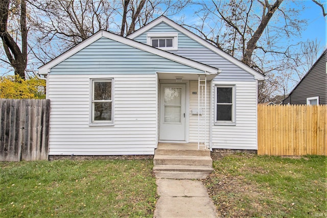 bungalow-style house featuring a front yard