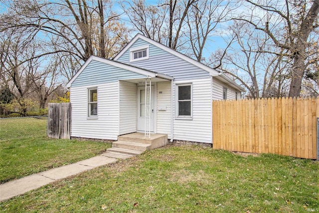 bungalow-style house with a front lawn