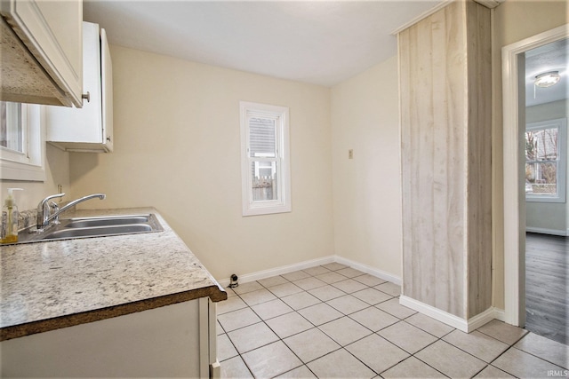 kitchen featuring sink and light tile patterned floors