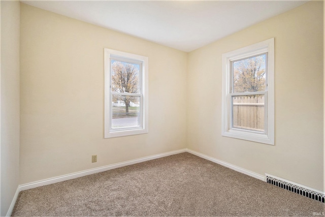 carpeted empty room with a healthy amount of sunlight