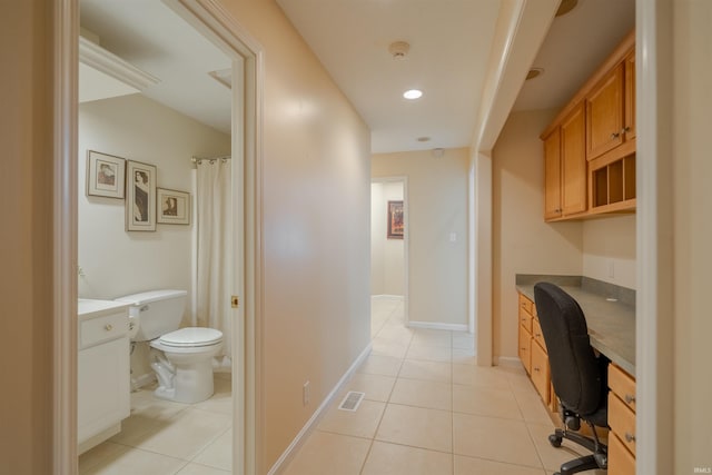 tiled office featuring built in desk