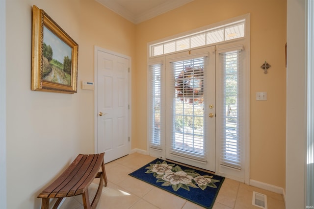 foyer featuring light tile patterned flooring and ornamental molding