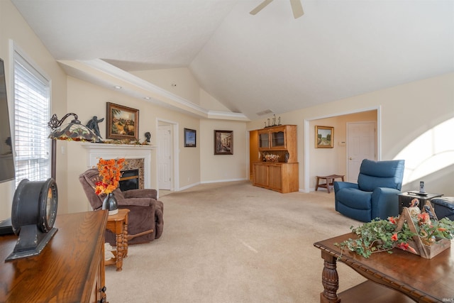 carpeted living room featuring lofted ceiling, ceiling fan, and a premium fireplace