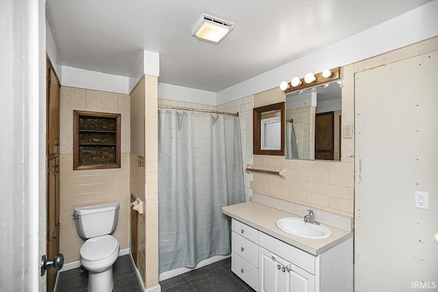 bathroom with vanity, tile patterned floors, and tile walls