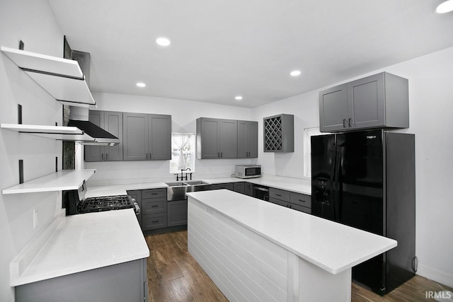 kitchen featuring gray cabinetry, dark wood-type flooring, black fridge, sink, and range