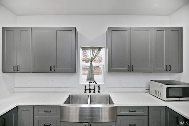 kitchen with gray cabinetry and sink