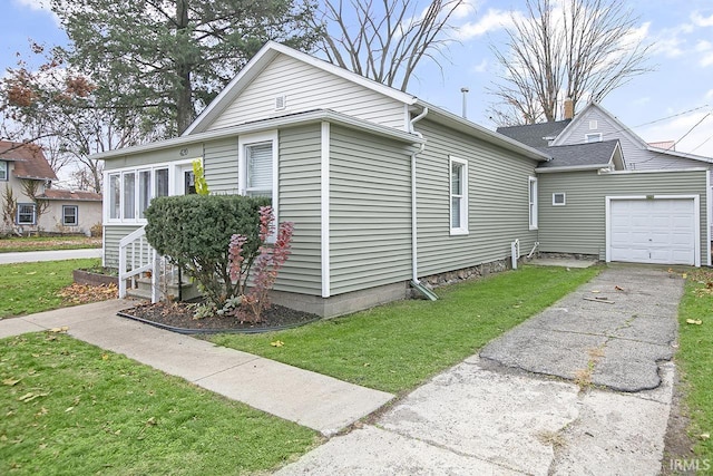 view of side of home featuring a yard and a garage