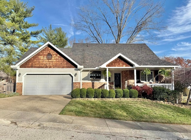 view of front facade with covered porch, a garage, and a front yard