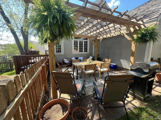 view of patio / terrace with area for grilling and a pergola