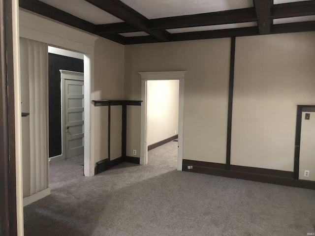 unfurnished room with carpet floors, beamed ceiling, and coffered ceiling