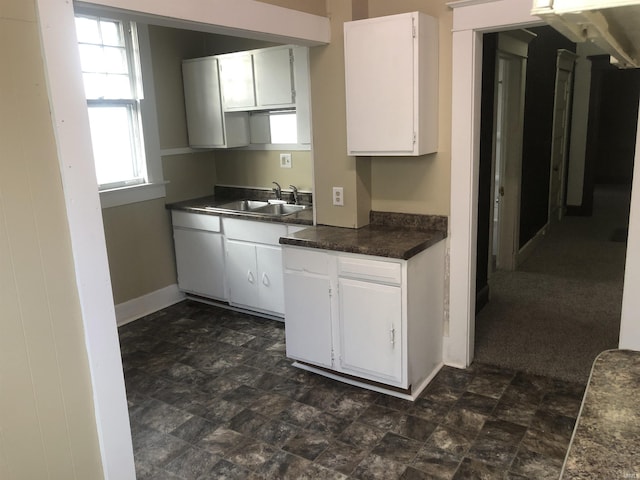 kitchen featuring sink and white cabinets