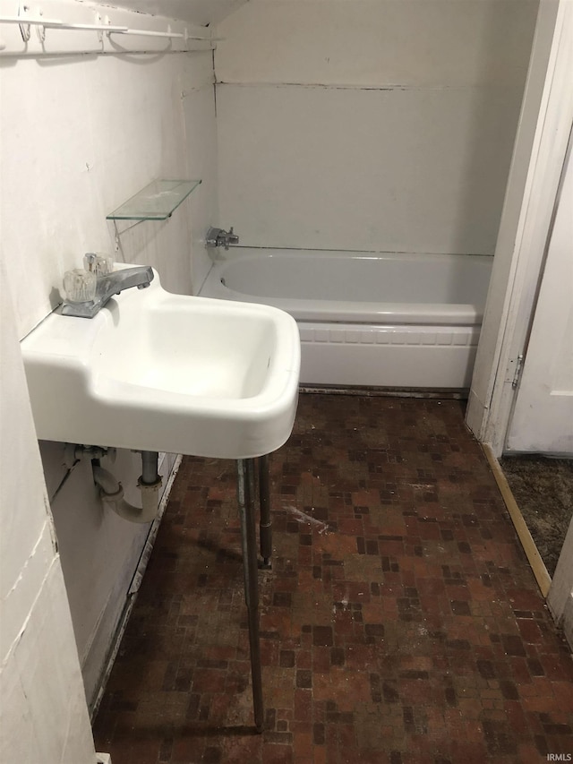 bathroom with a tub and sink