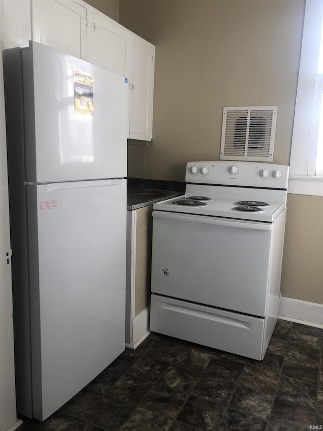 kitchen featuring white appliances and white cabinetry