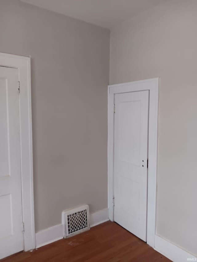 empty room with dark hardwood / wood-style floors