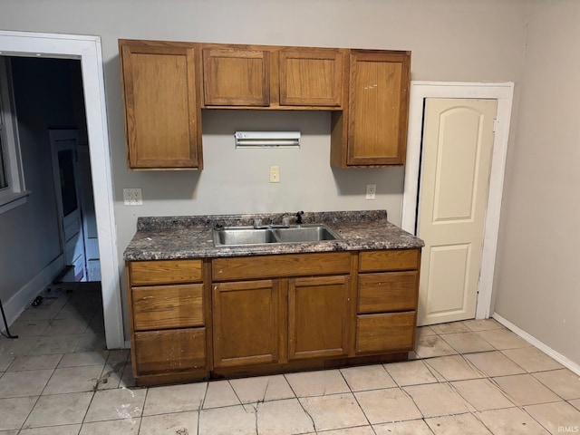 kitchen featuring sink and light tile patterned floors