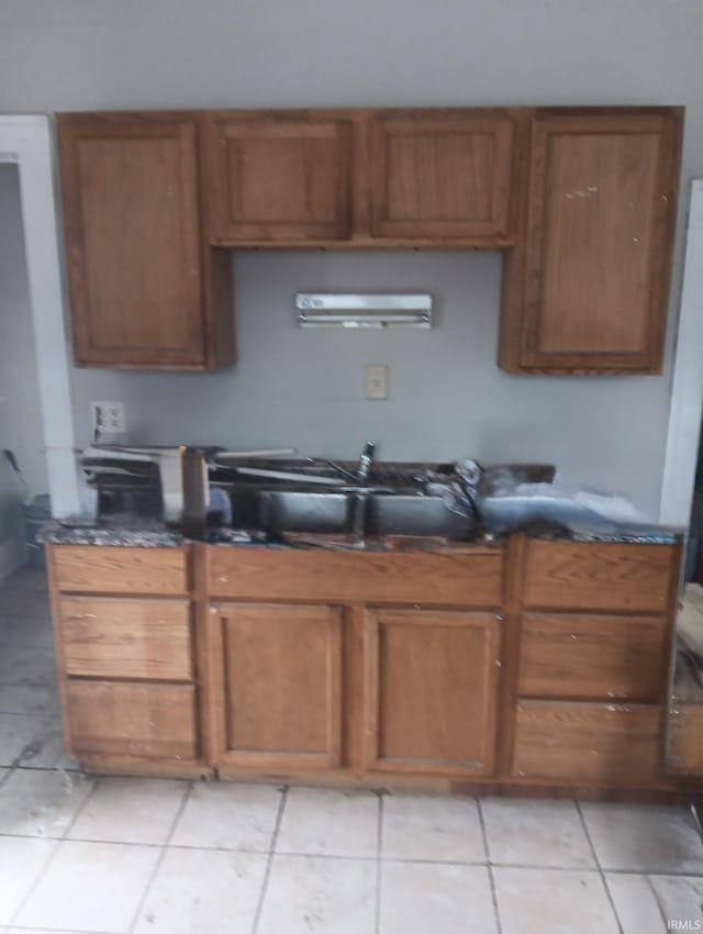 kitchen featuring light tile patterned floors and sink