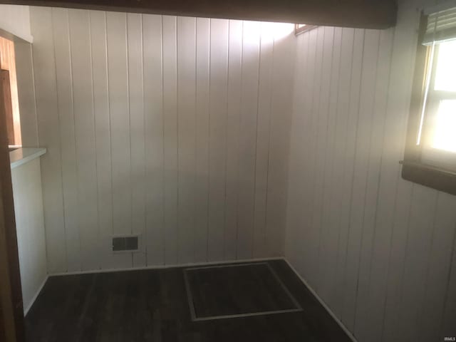 spare room with wood walls