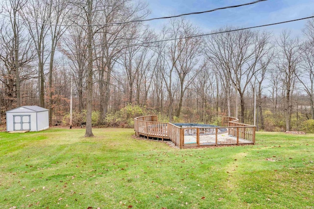 view of yard with a storage shed and a wooden deck