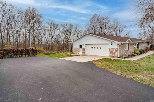 view of property exterior with a garage and a lawn