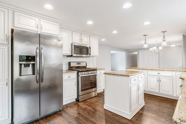 kitchen featuring white cabinetry, dark wood-type flooring, pendant lighting, and appliances with stainless steel finishes