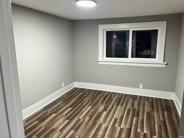 spare room with dark wood-type flooring