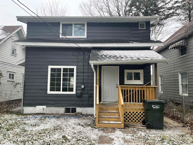 view of snow covered rear of property