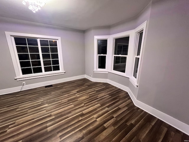 spare room featuring dark wood-type flooring