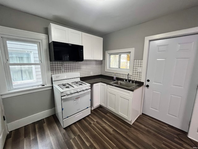 kitchen featuring white cabinets, white gas stove, sink, and tasteful backsplash