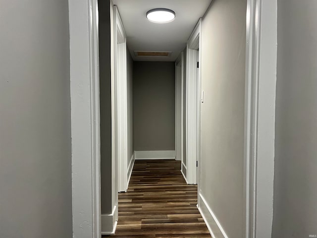 hallway with dark hardwood / wood-style floors