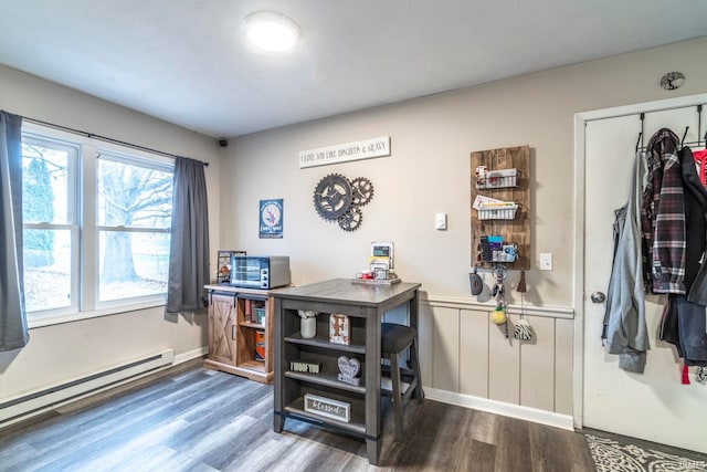 office with wood-type flooring and a baseboard heating unit