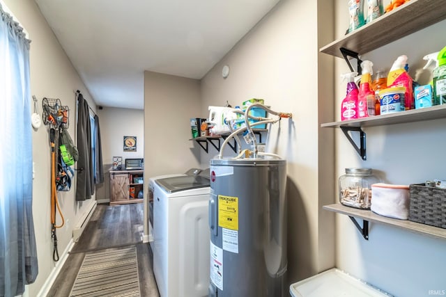 washroom with washer and dryer, electric water heater, and dark wood-type flooring