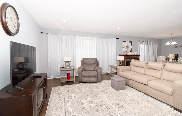 living room with hardwood / wood-style floors and a notable chandelier