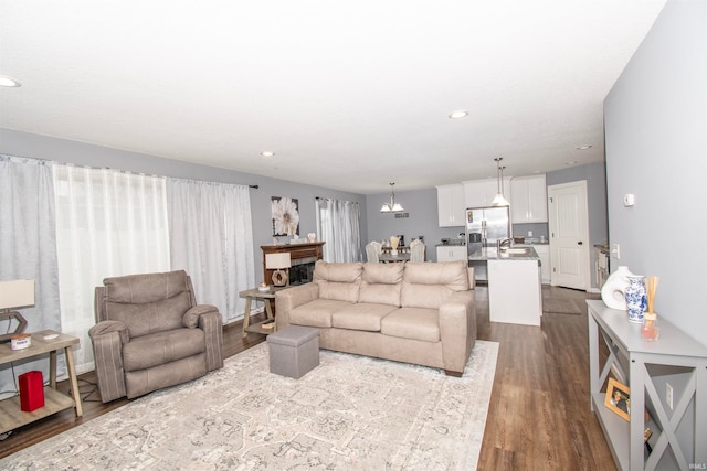 living room with hardwood / wood-style floors and sink