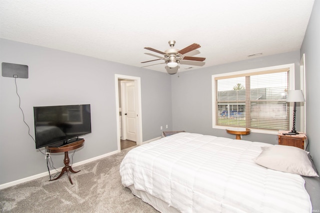 bedroom featuring carpet, a textured ceiling, and ceiling fan