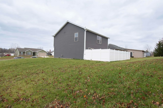 view of side of home with a lawn