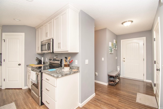 kitchen featuring white cabinetry, light hardwood / wood-style flooring, and stainless steel appliances