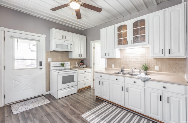 kitchen featuring white cabinets, dark hardwood / wood-style flooring, and white appliances