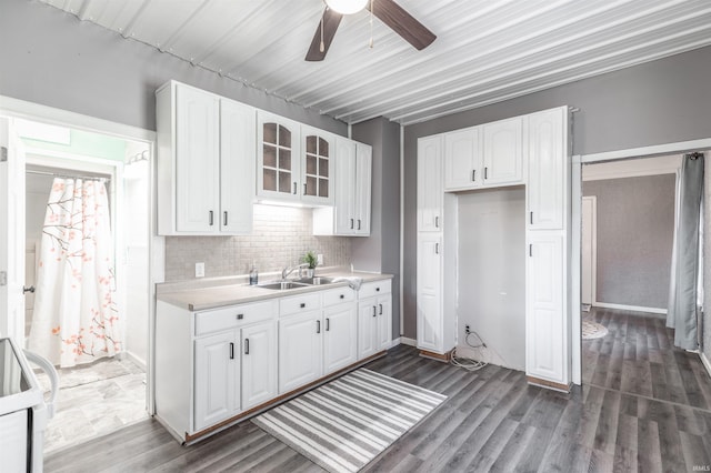 kitchen featuring white stove, white cabinetry, dark hardwood / wood-style floors, and decorative backsplash