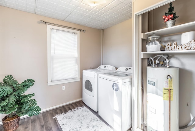 washroom featuring electric water heater, dark hardwood / wood-style floors, and washing machine and clothes dryer