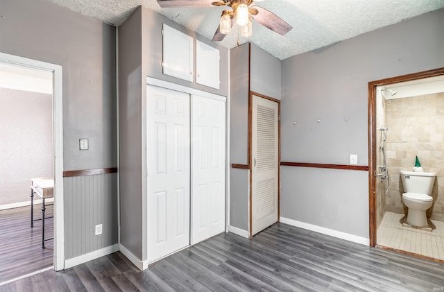 unfurnished bedroom with a closet, dark wood-type flooring, and a textured ceiling