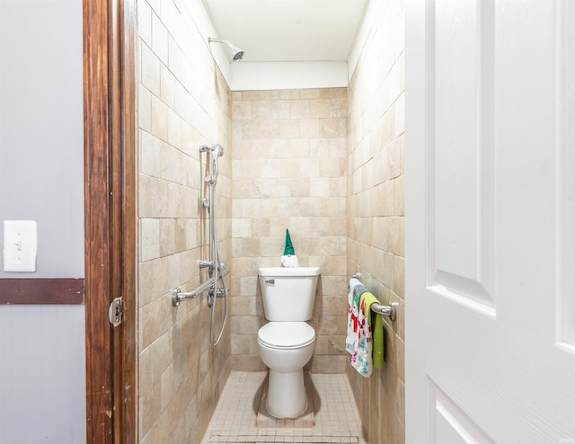 bathroom with a tile shower and toilet