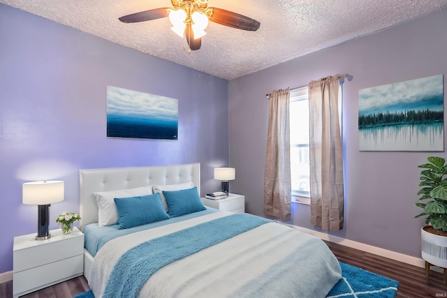 bedroom featuring a textured ceiling, ceiling fan, and dark wood-type flooring