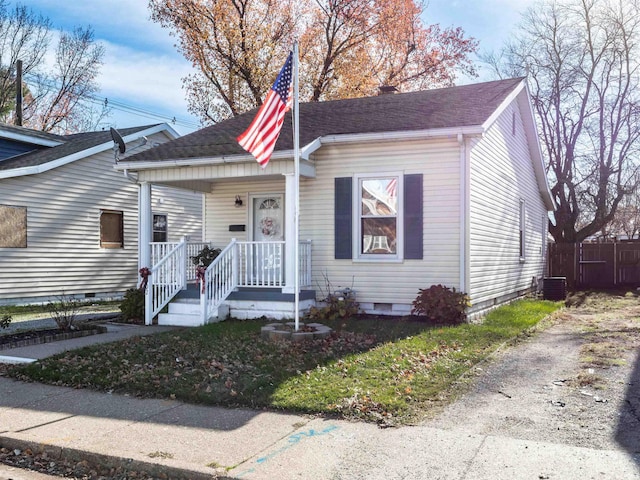 bungalow-style house with central AC unit and a porch