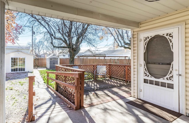 view of patio with a wooden deck and a shed