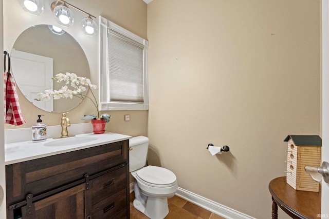 bathroom featuring tile patterned floors, vanity, and toilet