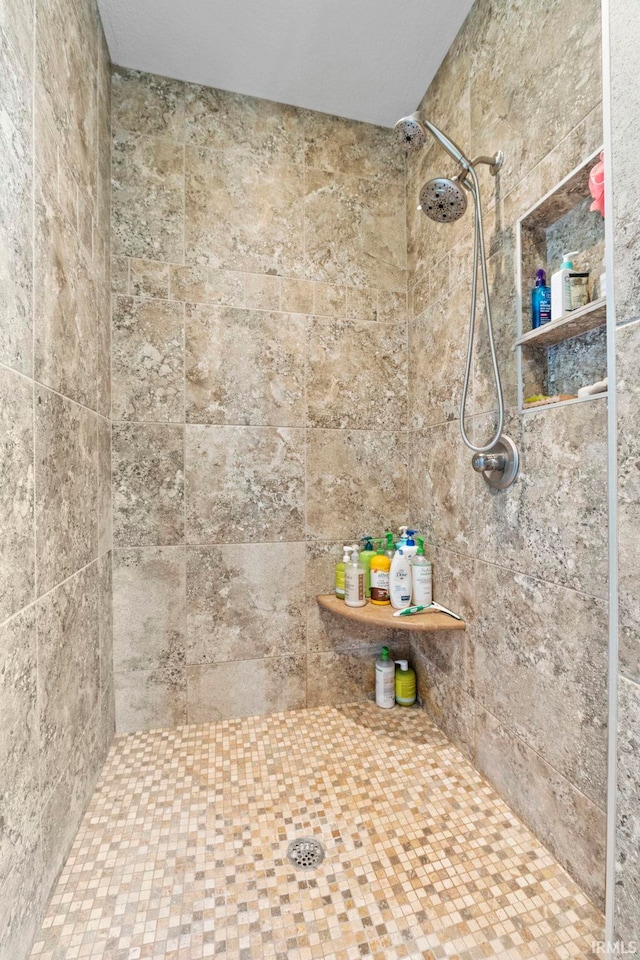 bathroom with a tile shower